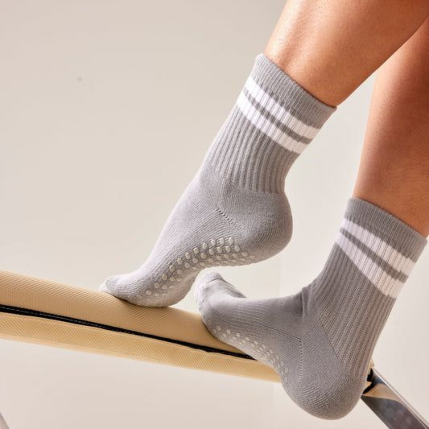 Gray non-slip pilates socks for women on exercise beam – The Fit Fab Co