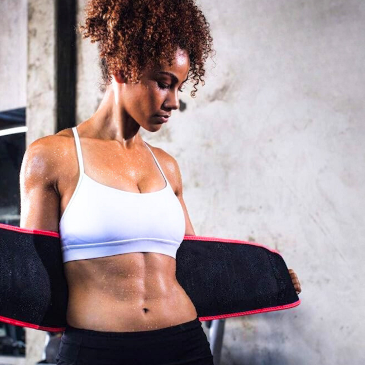 Sweaty woman tightening waist belt for post-workout support – The Fit Fab Co