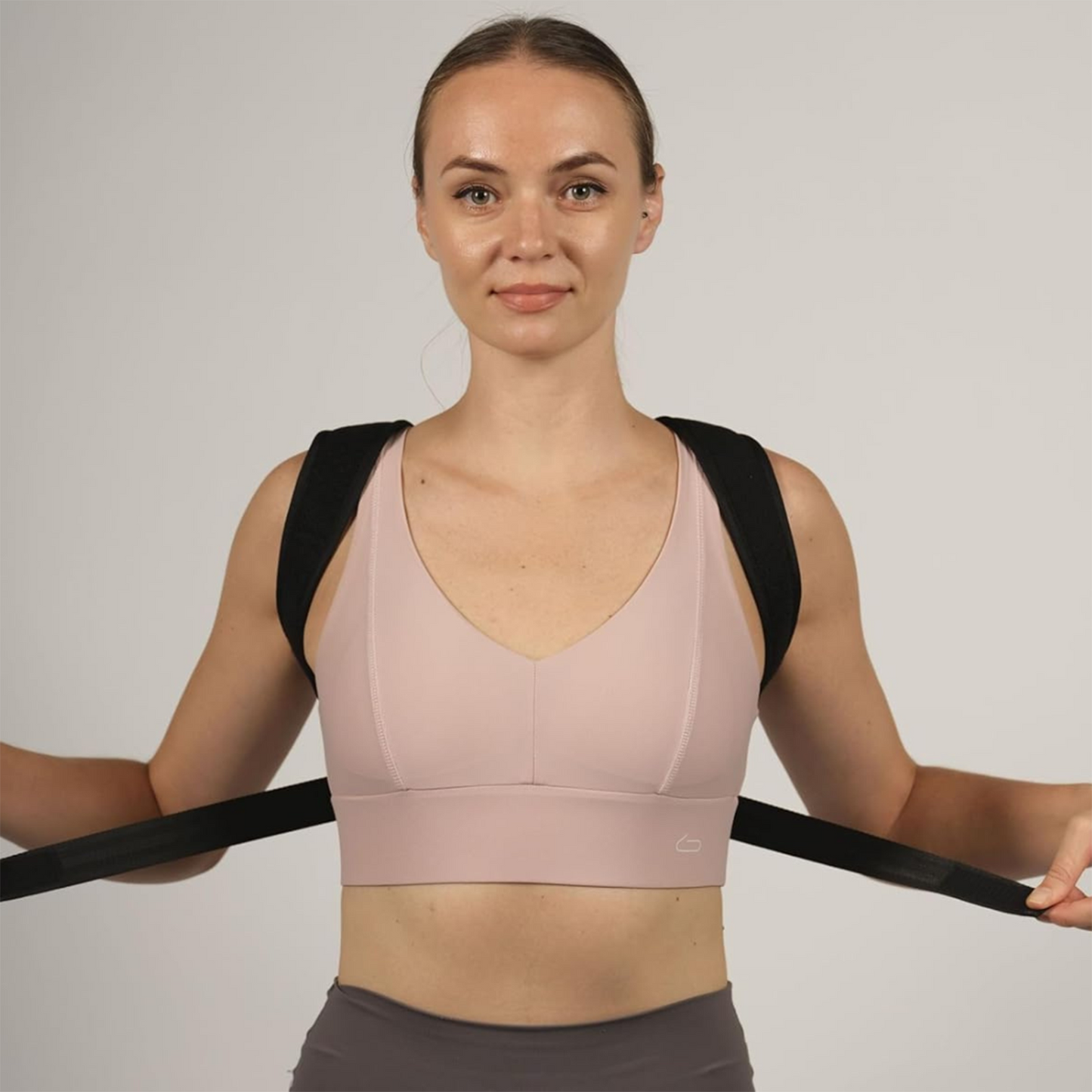 Front view of woman adjusting posture corrector harness – The Fit Fab Co
